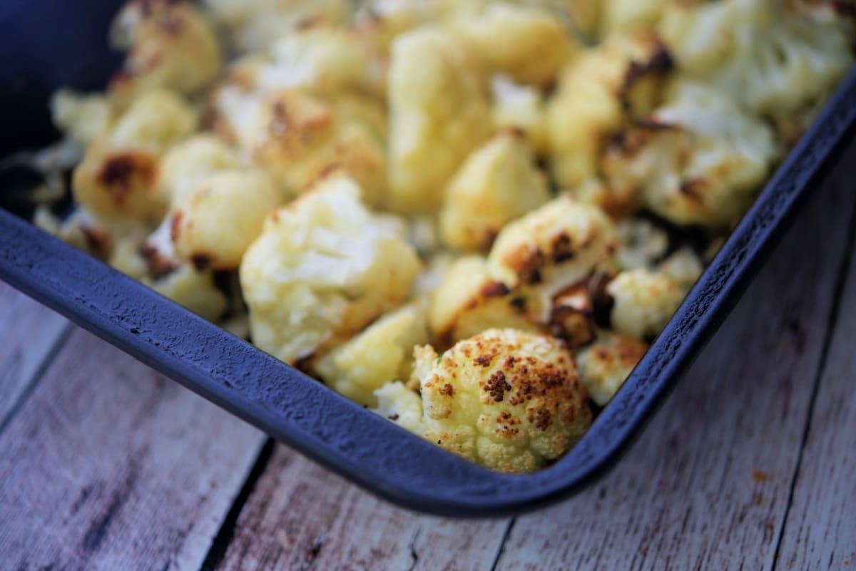 a close up of garlic cauliflower in a pan