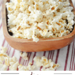 popcorn in a brown wooden bowl on a napkin