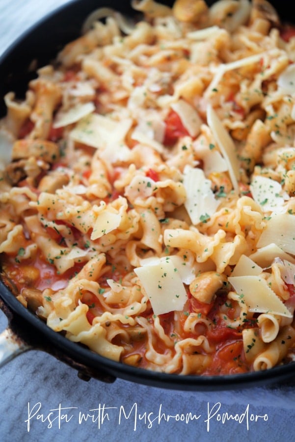 pasta with tomatoes and mushrooms in a skillet