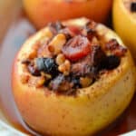 a close up of a cooked baked apple in a dish