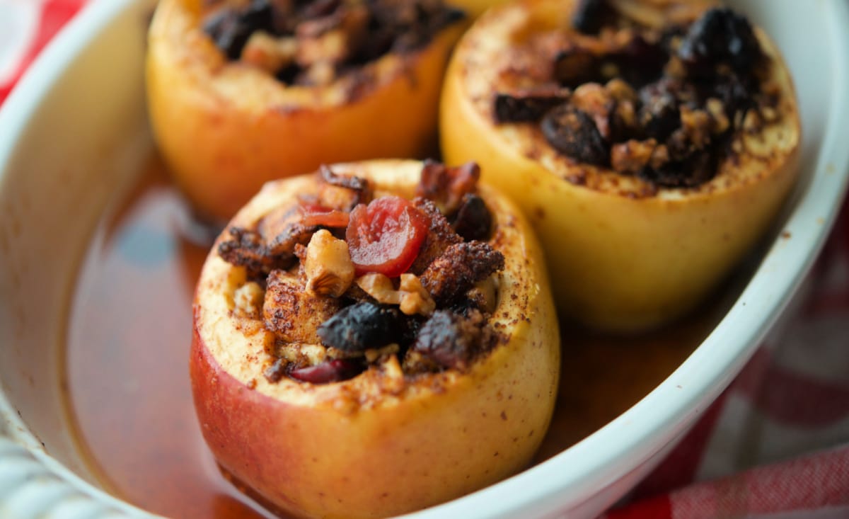 a close up of apples in a white dish