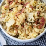 a bowl of risotto with corn and bacon