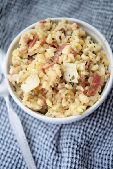 corn risotto with bacon in a white bowl