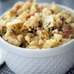 risotto with bacon in a white bowl