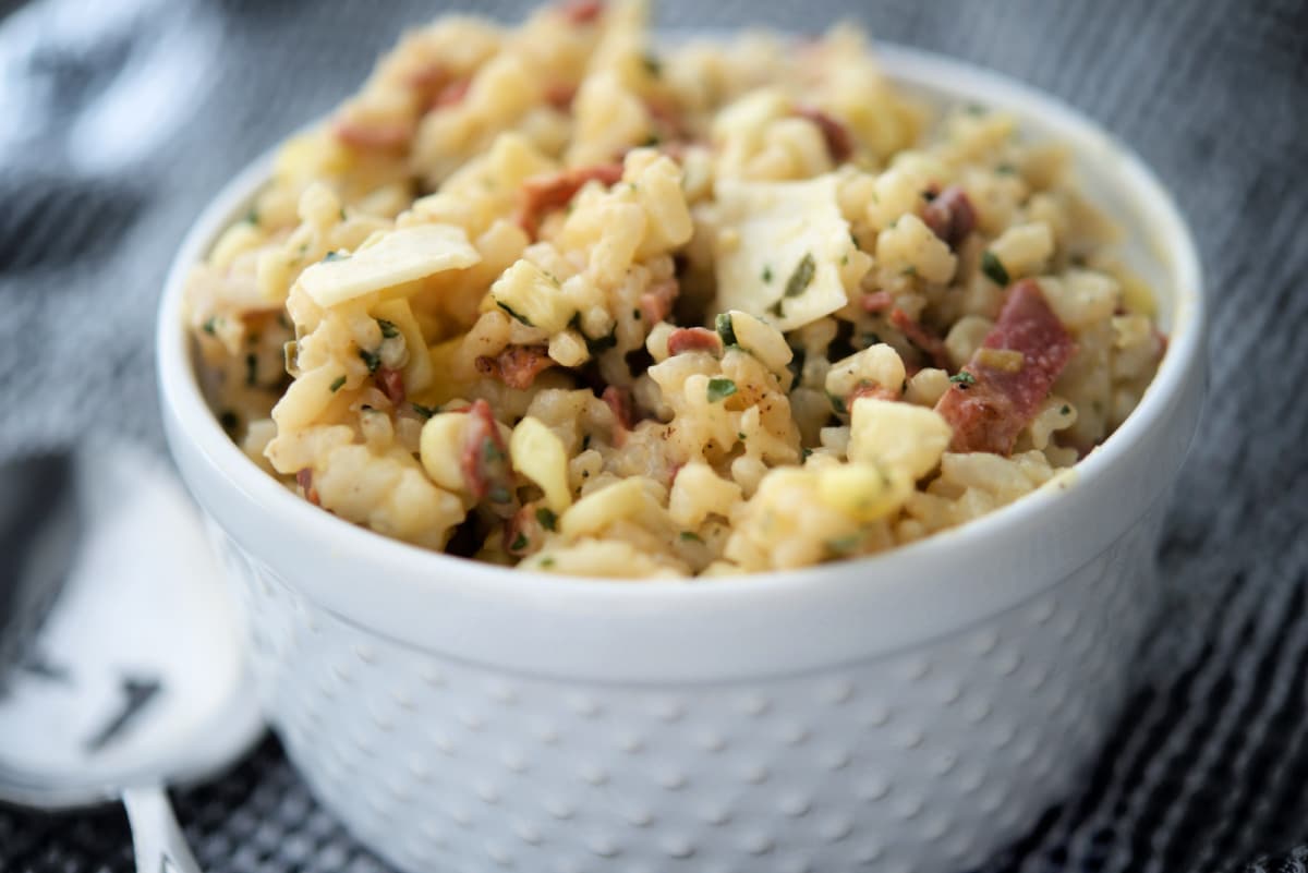 risotto with bacon in a white bowl