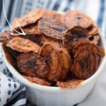 homemade banana chips in a white dish
