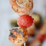 shrimp on a skewer with a tomato