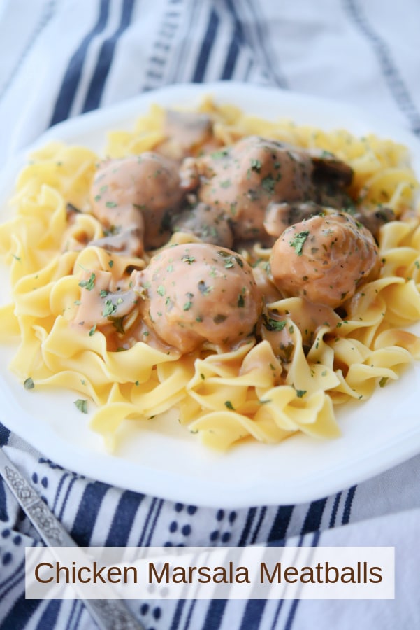 a plate of meatballs on top of egg noodles