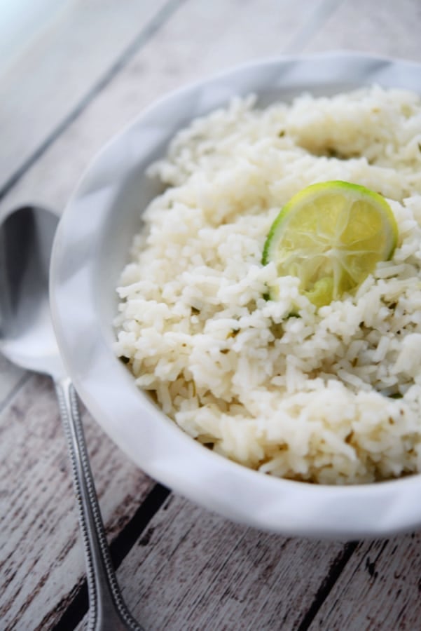 rice in a bowl with a slice of lime