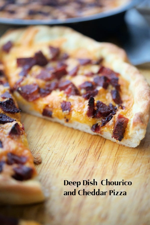 pizza on a wooden board with a slice cut out