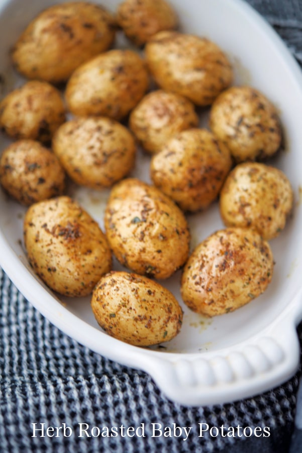 new potatoes with herbs in a white dish