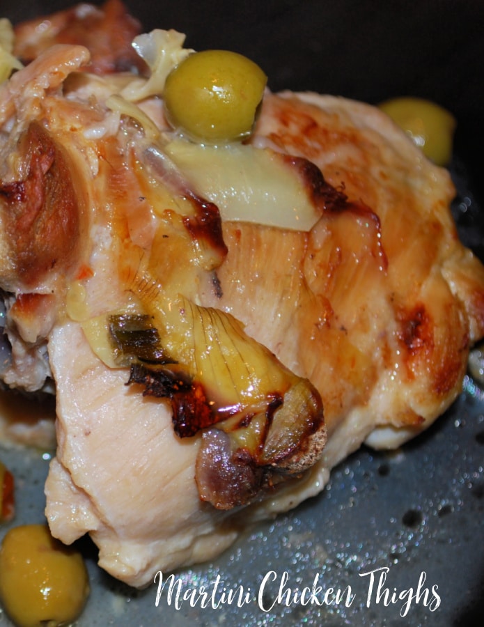 chicken thighs on a plate with olives