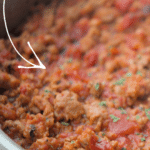 a close up of sausage bolognese in a steel skillet