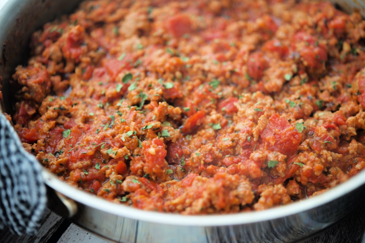 a close up of meat sauce with sausage 