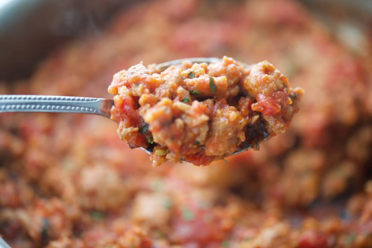 bolognese with sausage on a spoon