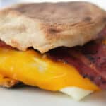 a close up of a breakfast sandwich with bacon