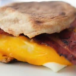 a close up of a breakfast sandwich with bacon