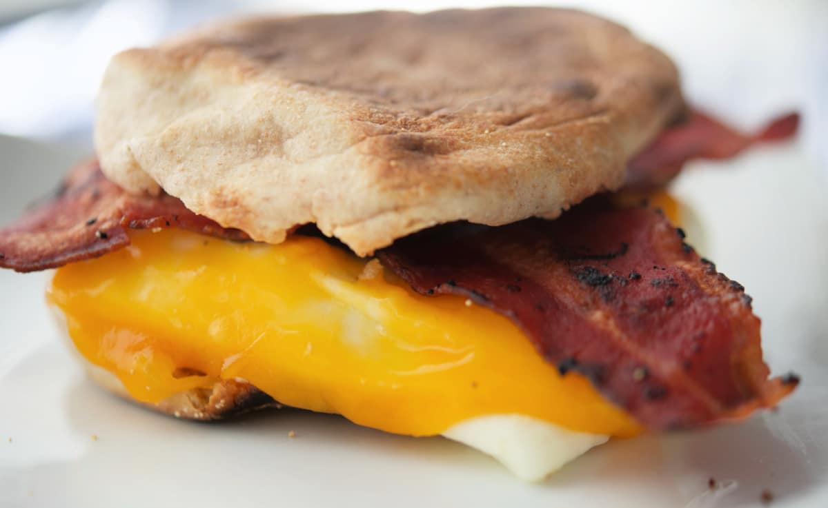 a close up of a breakfast sandwich with bacon