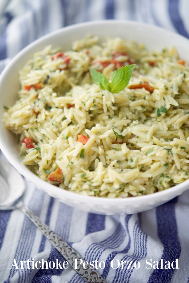 a bowl of orzo salad with artichoke hearts