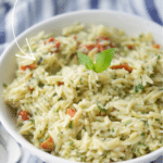 orzo salad with artichoke pesto in a white bowl