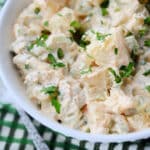 cajun lime potato salad in a bowl with a spoon on a green napkin