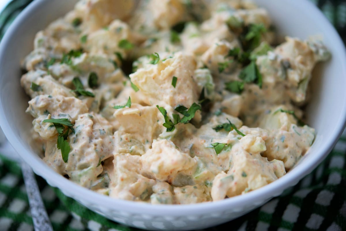 a close up of potato salad in a bowl