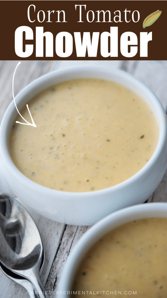 corn tomato chowder in a white soup bowl on a wooden board