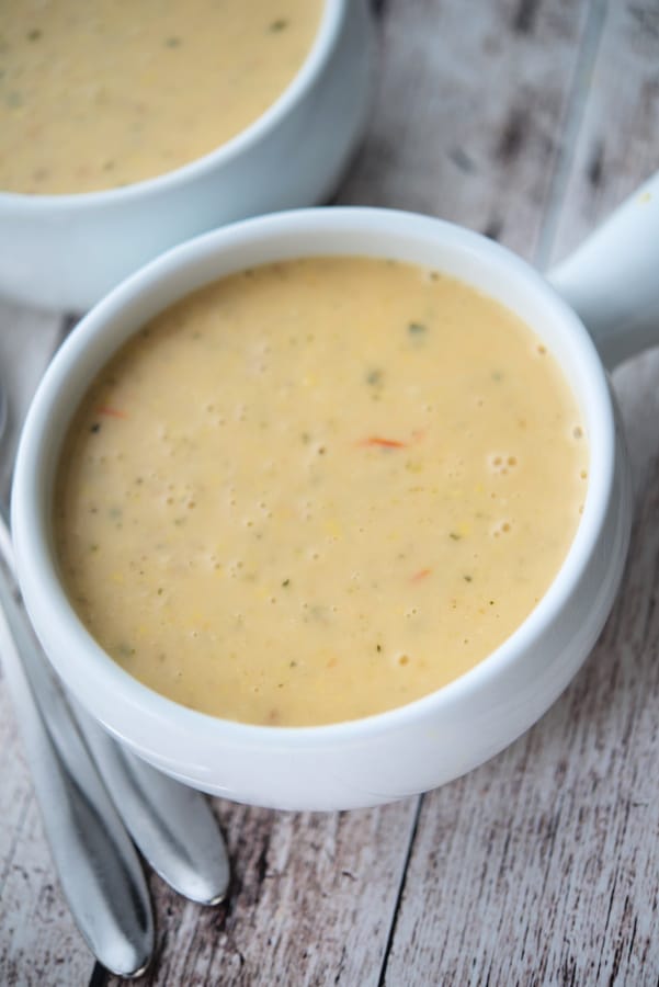 corn tomato chowder in a white soup crock