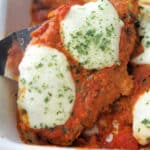 a close up of drunken chicken parmesan in a dish