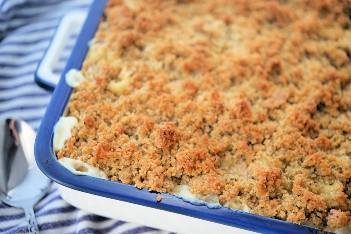 a close up of cooked mac and cheese in a blue and white baking dish