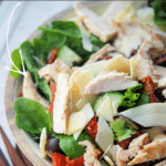 tuscan mixed green salad in a bowl with chicken