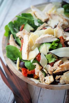 mixed salad with chicken in a wooden bowl