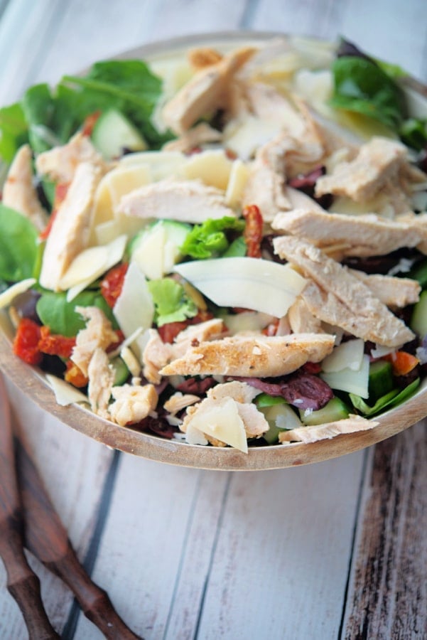 a bowl of salad on a wooden background 