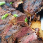 two steaks sliced on a wooden board