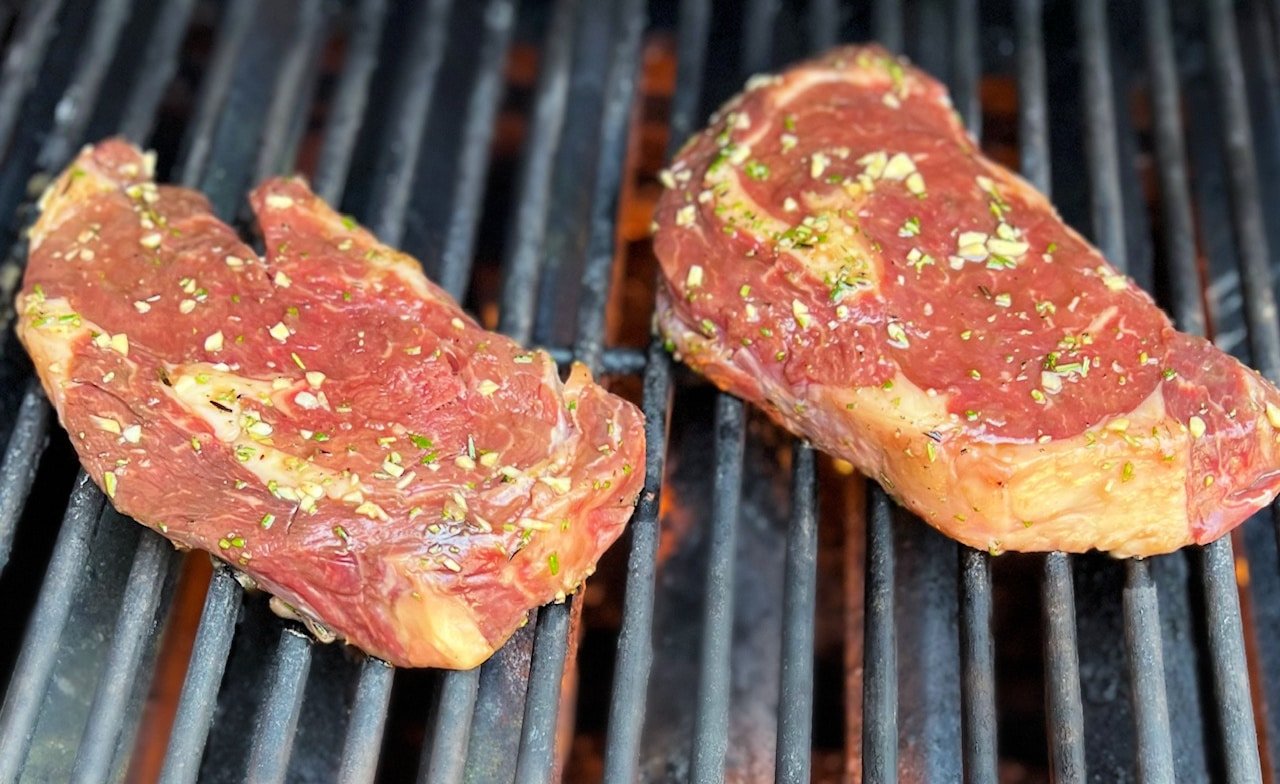 uncooked steak on a grill
