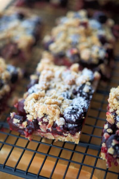 a close up of blueberry crumb dessert on a cooling rack
