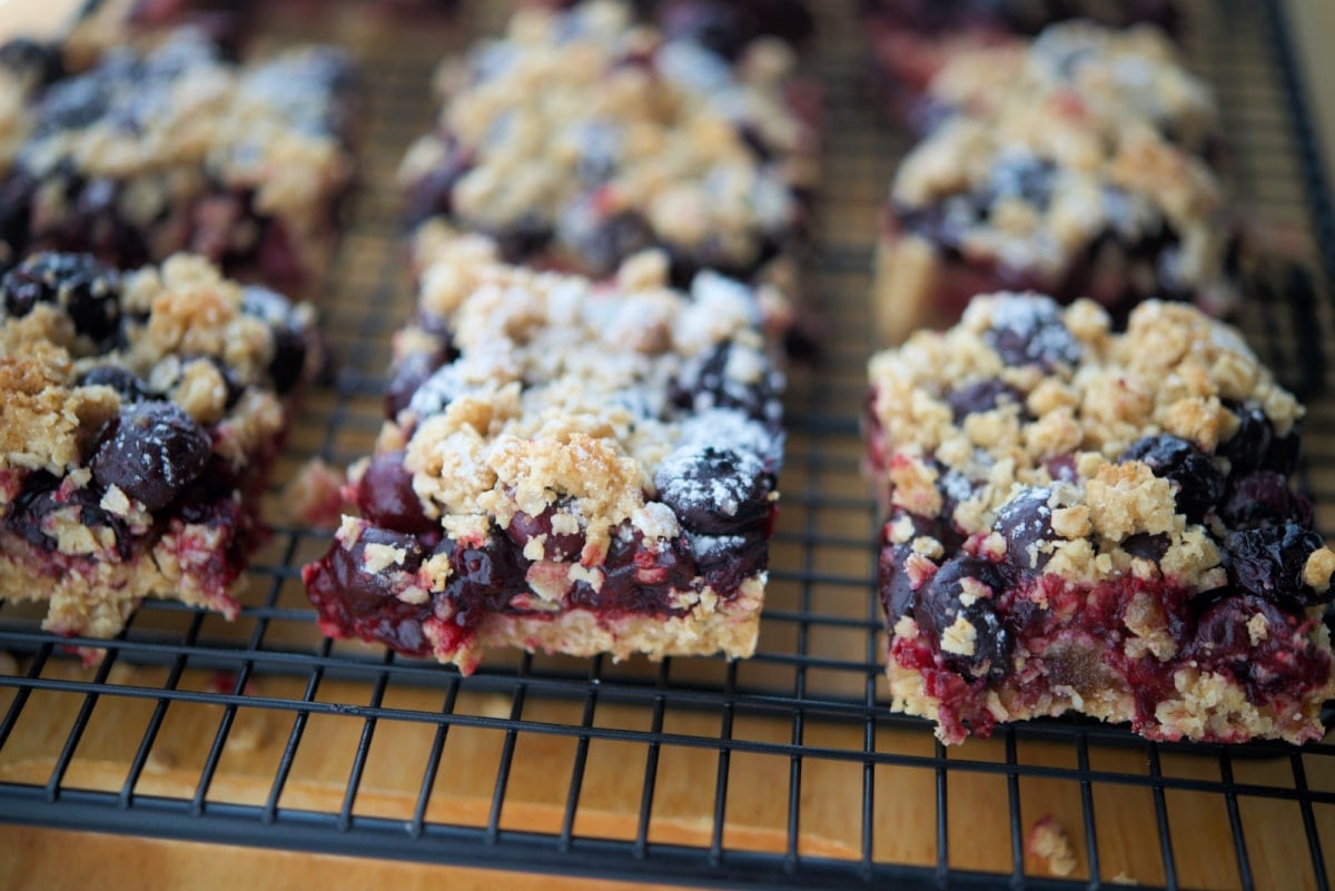 crumb bars with blueberries on a cooling rack