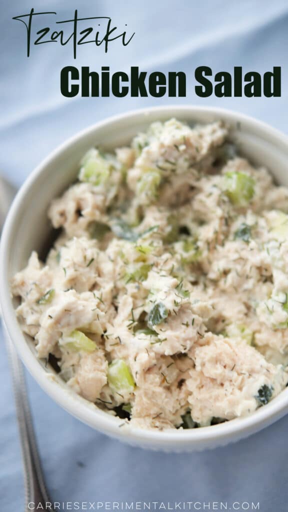 chicken salad made with tzatziki in a white bowl on a napkin with a spoon