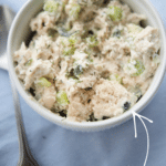 a white bowl filled with chicken salad made with tzatziki