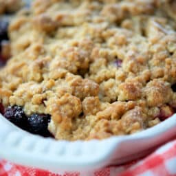 a close up of a dish of blueberry apple crisp