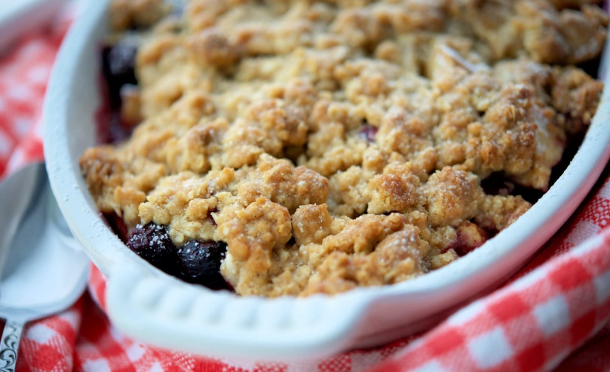a close up of a dish of blueberry apple crisp