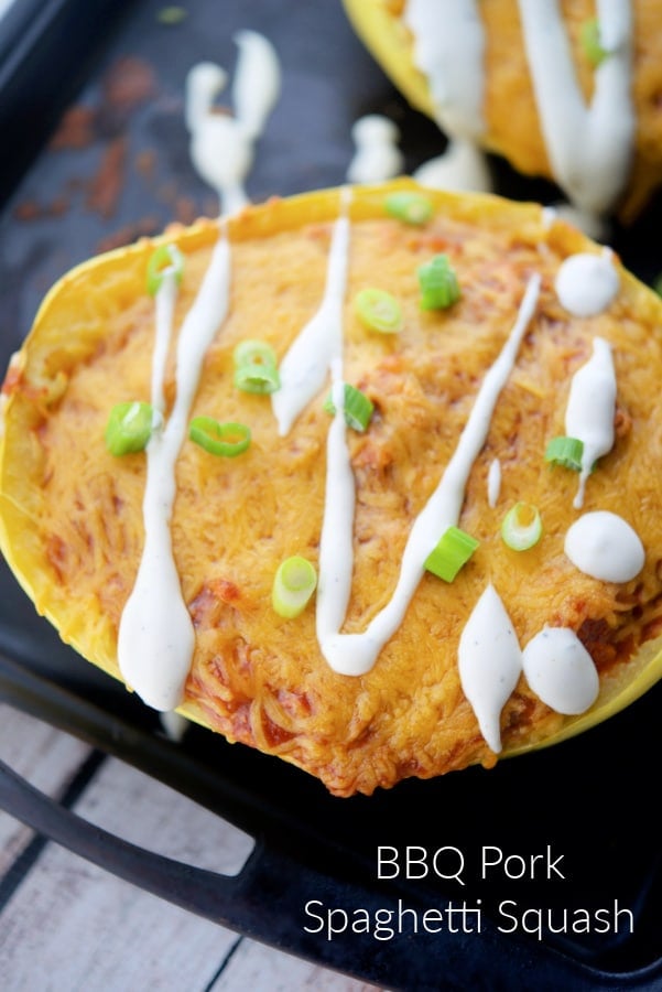 cooked spaghetti squash stuffed with bbq pork on a black tray