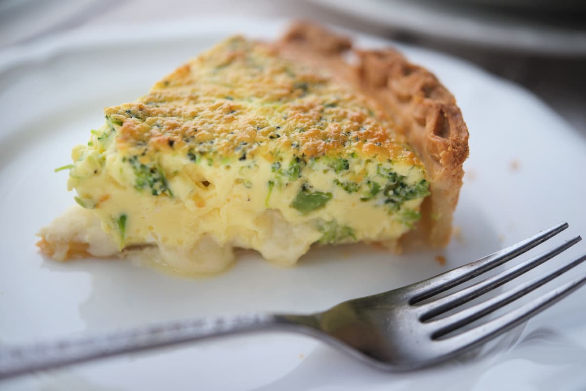 a close up of a piece of broccoli quiche