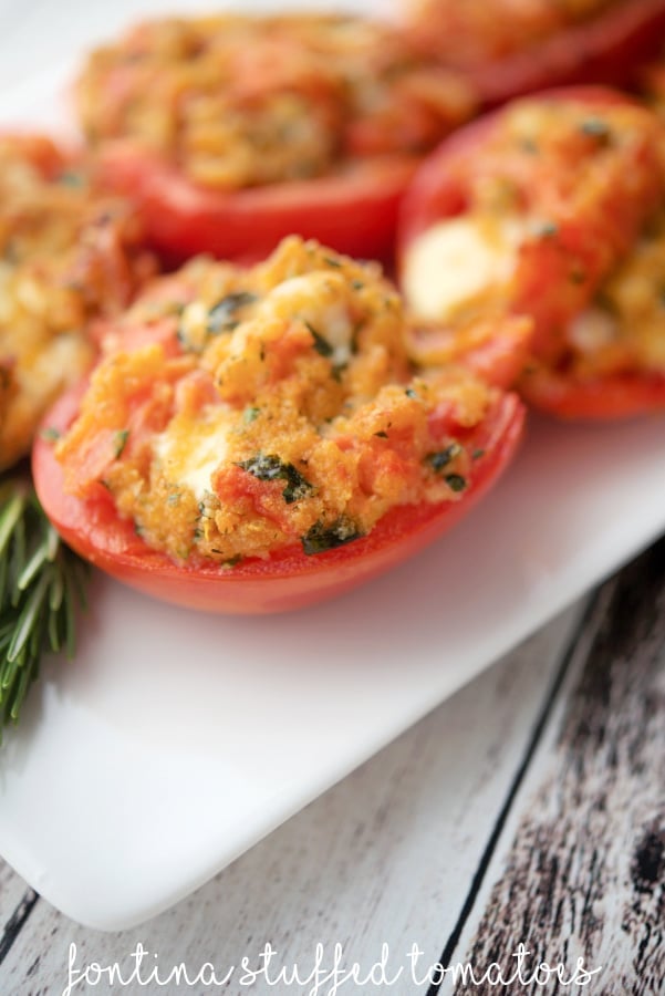 a plate of roma tomatoes stuffed with fontina cheese