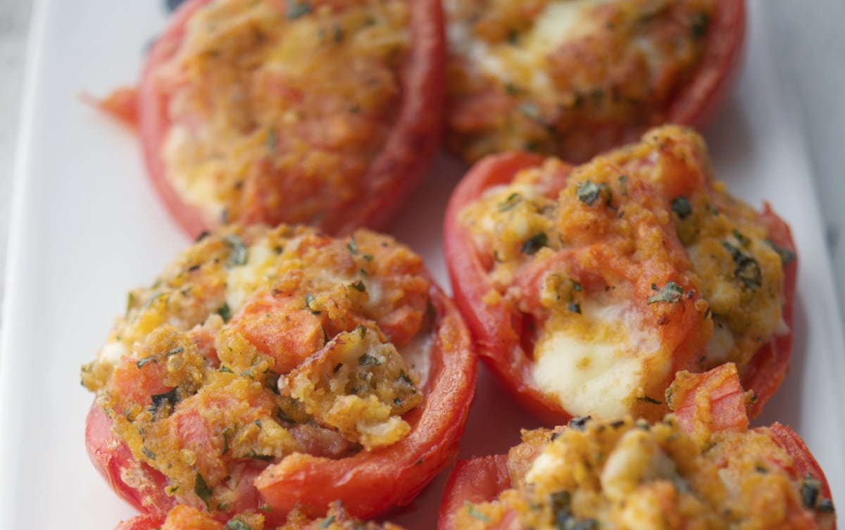 a close up of stuffed tomatoes with cheese