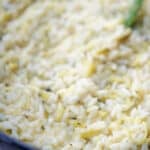 a close up of risotto with zucchini and lemon