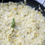cooked risotto with zucchini and lemon in a pan