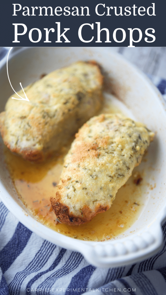 two pork chops crusted with parmesan cheese in a white baking dish