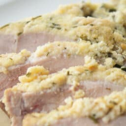 a close up of sliced pork on a white plate