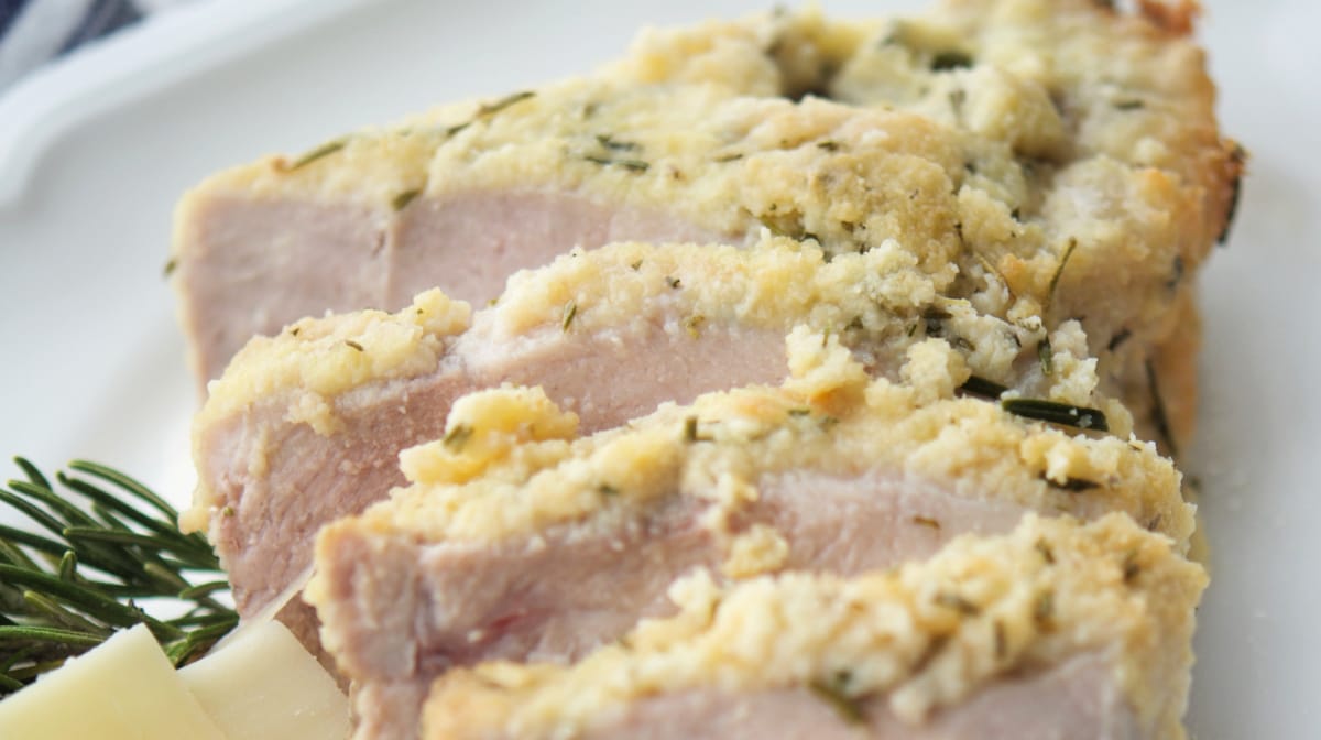 a close up of sliced pork on a white plate